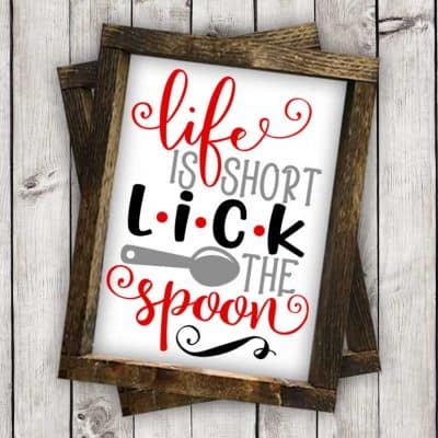 Download this free Life is Short Lick the Spoon SVG file to make a fun DIY kitchen sign. This free SVG file will work Cricut and Silhouette cutters.