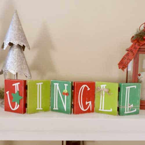 Make this darling Christmas sign with this easy to follow tutorial. With a few supplies and your Silhouette or Cricut machine, you'll be able to create this hinged Christmas block sign for your home home. This DIY project is easy and quick to make and is the perfect decoration for home. #ChristmasSilhouette #ChristmasCricut #ChristmasSVG