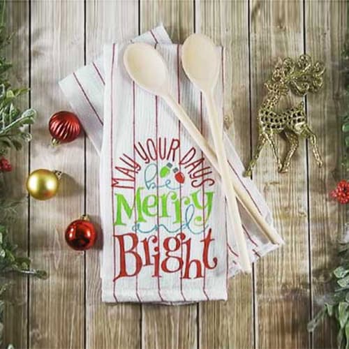 Make this cute Stenciled Dish Towel for Christmas with this easy to follow tutorial. With a few supplies and your Silhouette or Cricut machine, you'll be able to create this Stenciled Christmas Dish Towel for your home or as a gift. This DIY project is easy and quick to make and is the perfect decoration for home. #ChristmasSilhouette #ChristmasCricut #ChristmasSVG