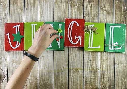 Make this darling Christmas sign with this easy to follow tutorial. With a few supplies and your Silhouette or Cricut machine, you'll be able to create this hinged Christmas block sign for your home home. This DIY project is easy and quick to make and is the perfect decoration for home. #ChristmasSilhouette #ChristmasCricut #ChristmasSVG
