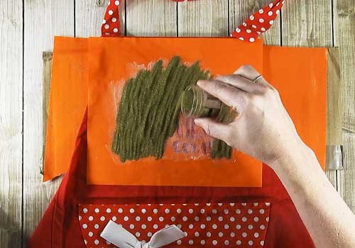 Make this cute heat embossed Apron for Christmas with this easy to follow tutorial. With a few tools and your Silhouette or Cricut machine, you'll be able to create this heat embossed Apron. This DIY project is easy and quick to make and is the perfect decoration for home. #ChristmasSilhouette #ChristmasCricut #ChristmasSVG