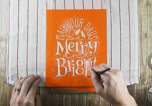 Make this cute Stenciled Dish Towel for Christmas with this easy to follow tutorial. With a few supplies and your Silhouette or Cricut machine, you'll be able to create this Stenciled Christmas Dish Towel for your home or as a gift. This DIY project is easy and quick to make and is the perfect decoration for home. #ChristmasSilhouette #ChristmasCricut #ChristmasSVG