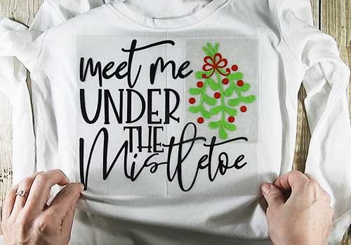 Make your own custom t-shirt for Christmas with this easy to follow tutorial. With a few tools and your Silhouette or Cricut machine, you'll be able to create this Christmas t-shirt. This DIY project is easy and quick to make and is the perfect addition to your holiday attire. #ChristmasSilhouette #ChristmasCricut #ChristmasSVG