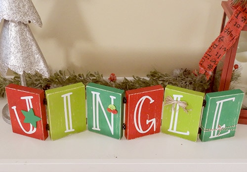 Make this darling Christmas sign with this easy to follow tutorial. With a few supplies and your Silhouette or Cricut machine, you'll be able to create this hinged Christmas block sign for your home home. This DIY project is easy and quick to make and is the perfect decoration for home. #ChristmasSilhouette #ChristmasCricut #ChristmasSVG