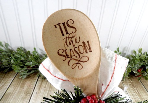 Learn how to make your own wood burned Christmas spoons with this easy to follow tutorial. With a few tools and your Silhouette or Cricut machine, you'll be able to create these cute wood burned Christmas spoons for your home or as gifts. This DIY project is easy and quick to make and is the perfect gift for family and friends. #ChristmasSilhouette #ChristmasCricut #ChristmasSVG