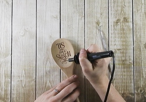 Learn how to make your own wood burned Christmas spoons with this easy to follow tutorial. With a few tools and your Silhouette or Cricut machine, you'll be able to create these cute wood burned Christmas spoons for your home or as gifts. This DIY project is easy and quick to make and is the perfect gift for family and friends. #ChristmasSilhouette #ChristmasCricut #ChristmasSVG